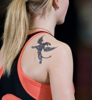 TATTOO SPORT. On a shoulder at Tatyana Kivimyagi of a tattoo a griffin.